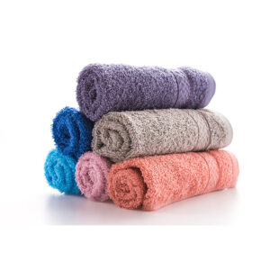 Stack of multicolored terry towels on a white background